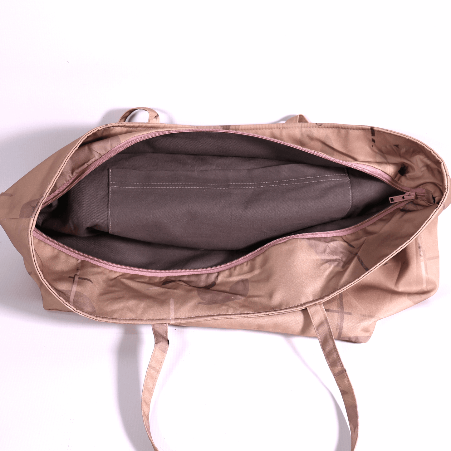 A dusky dark peach carryall bag with a stripe design. Top view. Zipper open.