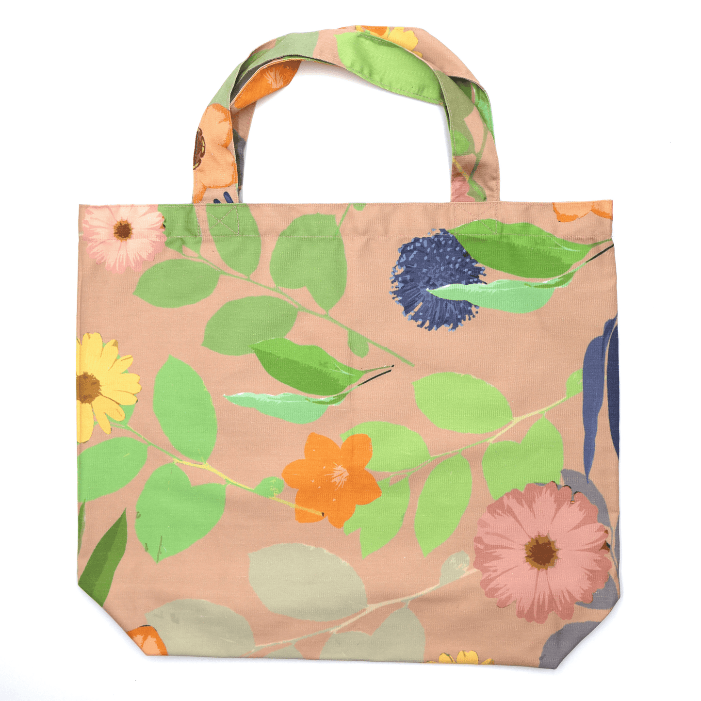 A high-quality tote bag with orange and yellow Daisy floral design on peach background. Flat view.