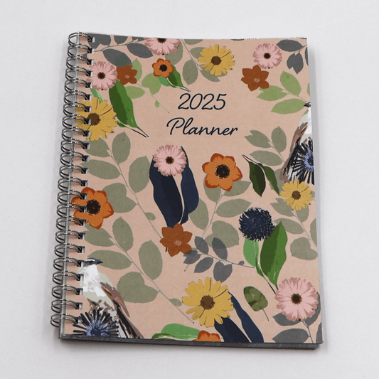 A5 Daily planner with bright daisy floral design on a peach background. Laminated flexi-cover.