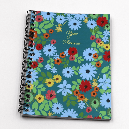 A5 Daily planner with bright daisy floral design on a blue background. Laminated flexi-cover.