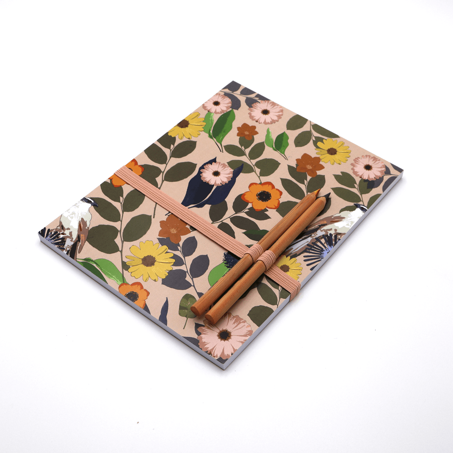 A4 Sketchpad with pencils and pencil holder with bright daisy floral design on a soft peach background.