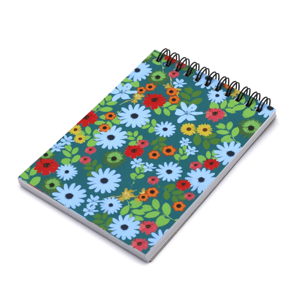 A6 Notebook in bright daisy floral design on a blue background. Top wire binding.