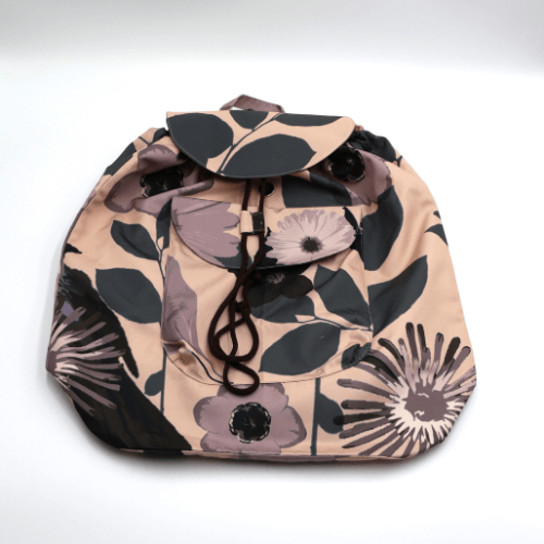 Lightweight backpack with drawstring and daisy floral design in mauve and dusky peach. Flat view.