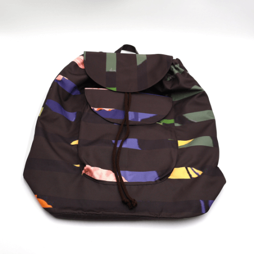 Lightweight backpack with drawstring and bright daisy floral and stripe design on dark brown/black background. Flat view.