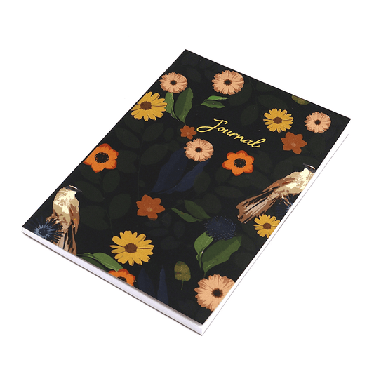 A5 journal with bright daisy floral design on black background.