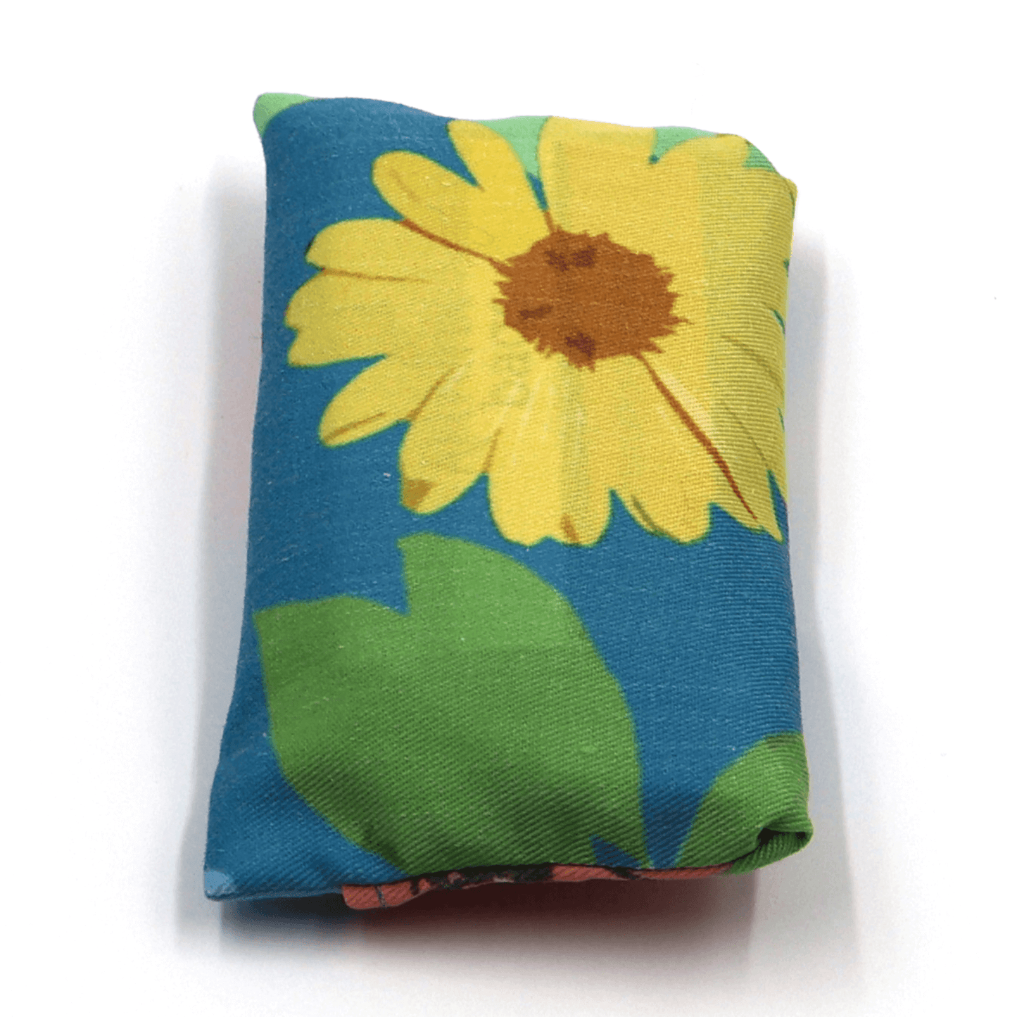 Fold up shopping bag with bright daisy design on blue background.