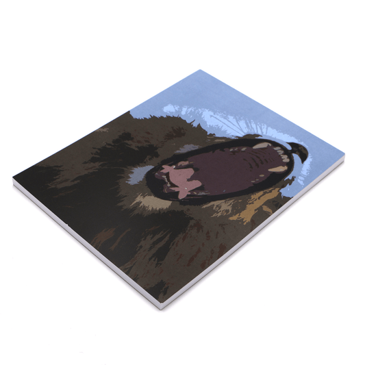 A4 sketchpad with face of yawning lion on a blue background.