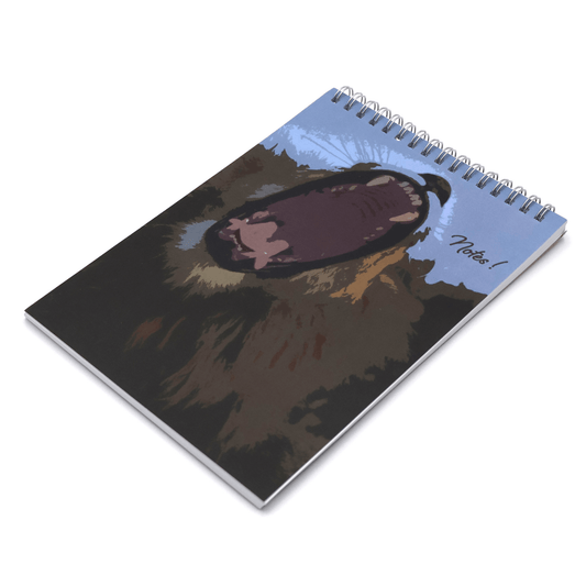 A5 journal with face of yawning lion on a blue background.