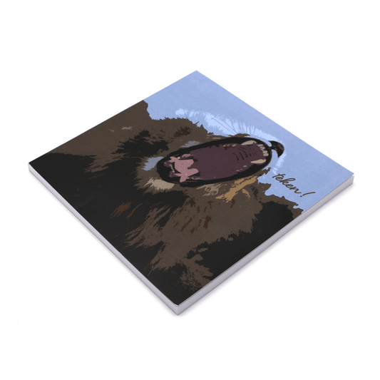 Square art pad with face of yawning lion on a blue background.