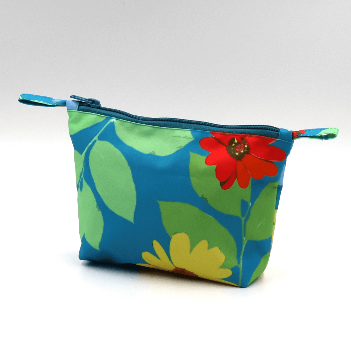 Colorful blue floral makeup bag with zipped closure, durable design, and easy-to-clean materials.