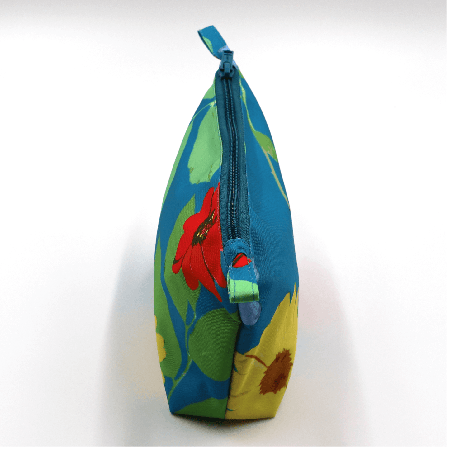 Side view of Ellie B Blue Darling makeup bag with floral design and zip closure, perfect for travel and beauty essentials.