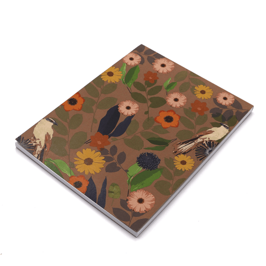 A4 sketchpad with daisy floral design on brown background.