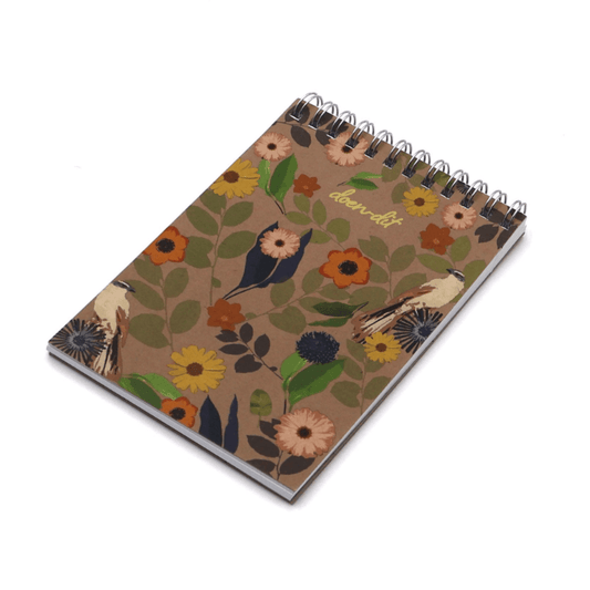 A6 Notebook with daisy floral design on a brown background. Top wire binding.