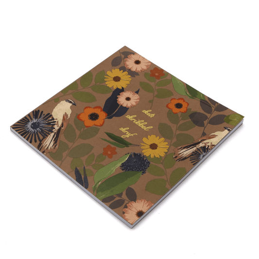 Square art pad with daisy floral design on brown background. Side binding.