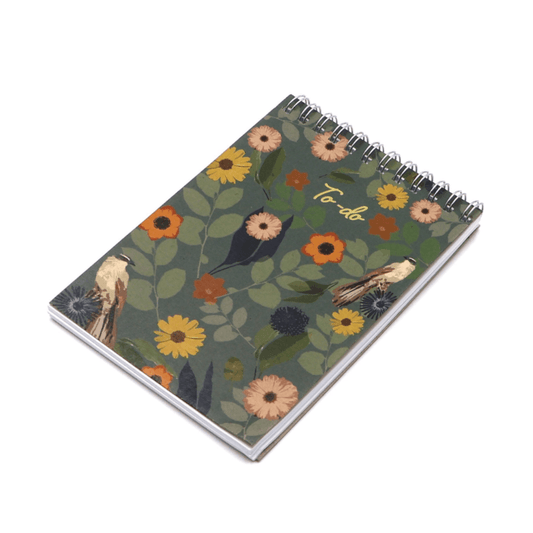 A6 Notebook with bright daisy floral design on dark green background. Top binding.