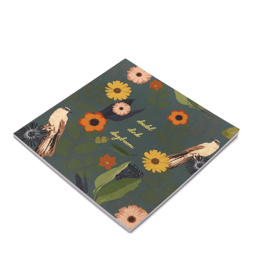 Square art pad with bright daisy floral design on dark green background.