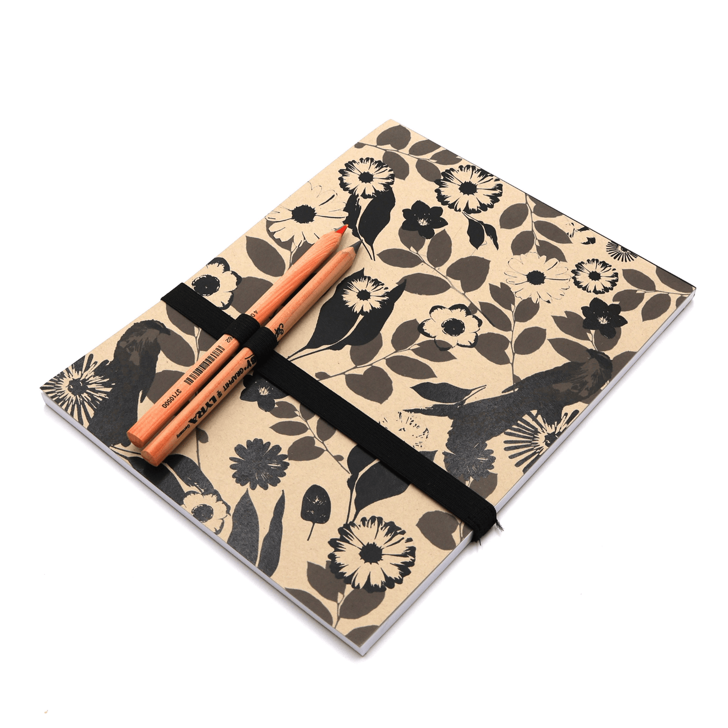 A4 Sketchpad with pencils and pencil holder with daisy floral design in black on a beige sand background.