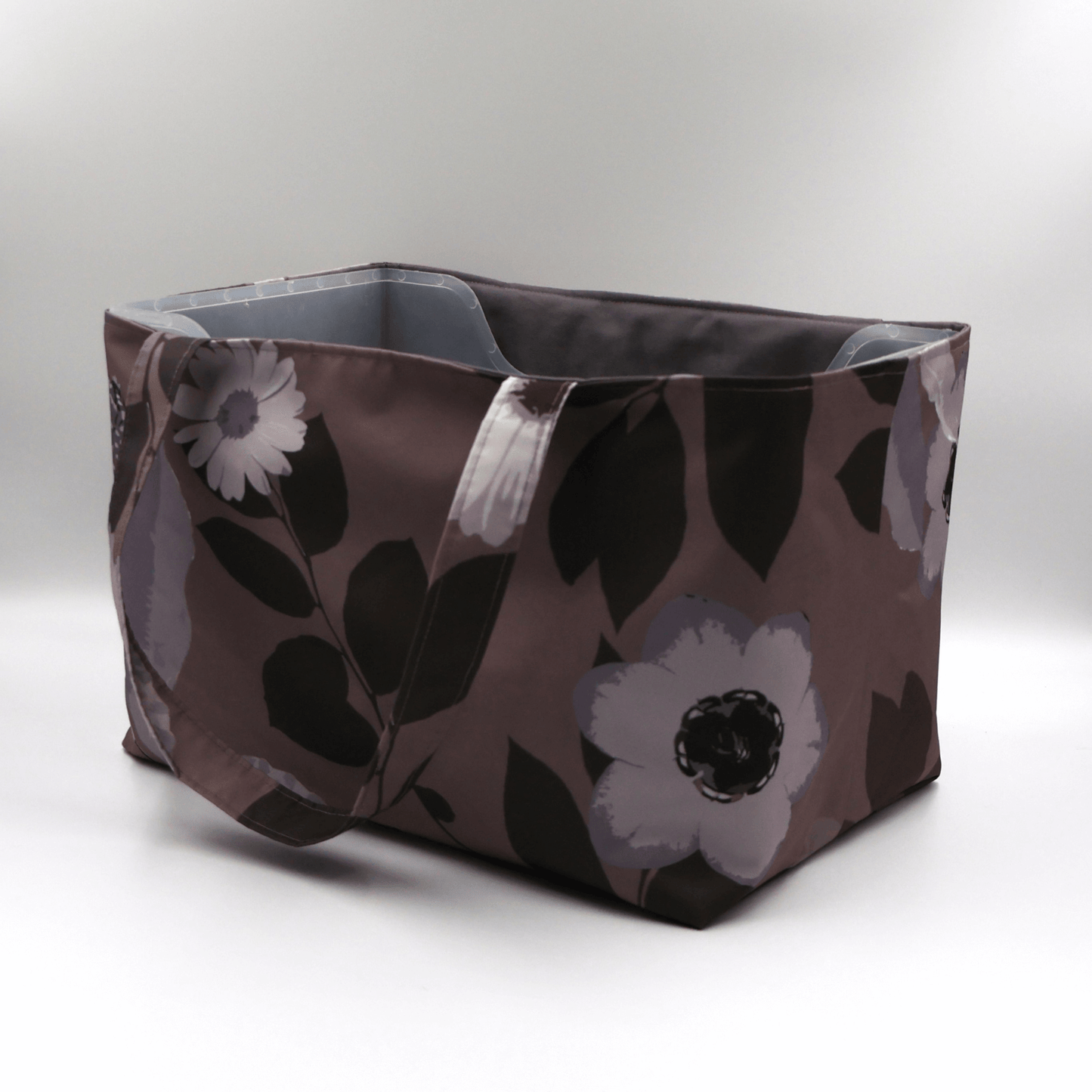 Large Teacher/book bag with light grey and mauve floral design on a dark mauve background. Carry books and crafts. Side.