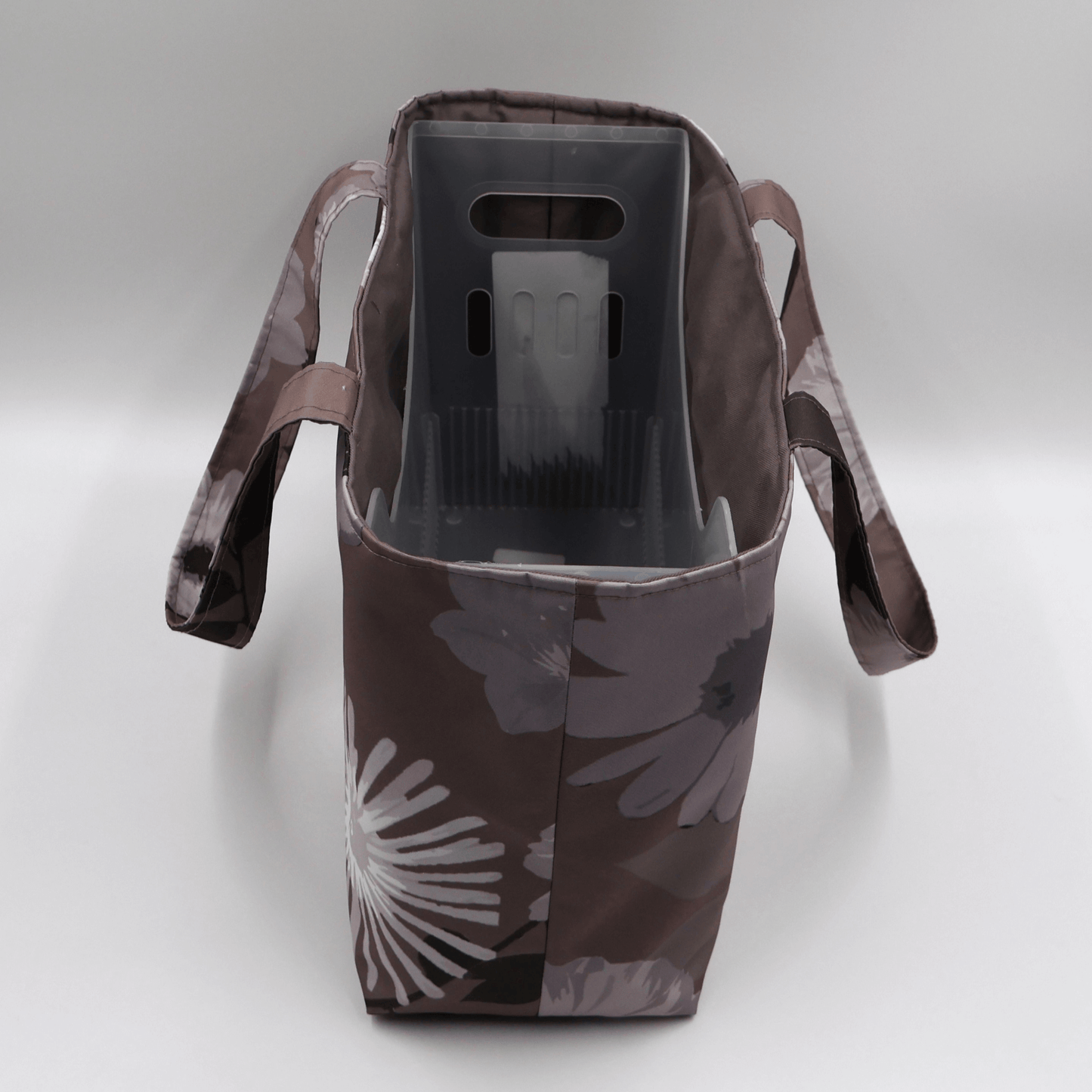 Teacher/book bag with light grey and mauve floral design on a dark mauve background. Carry books and crafts. With plastic inner.