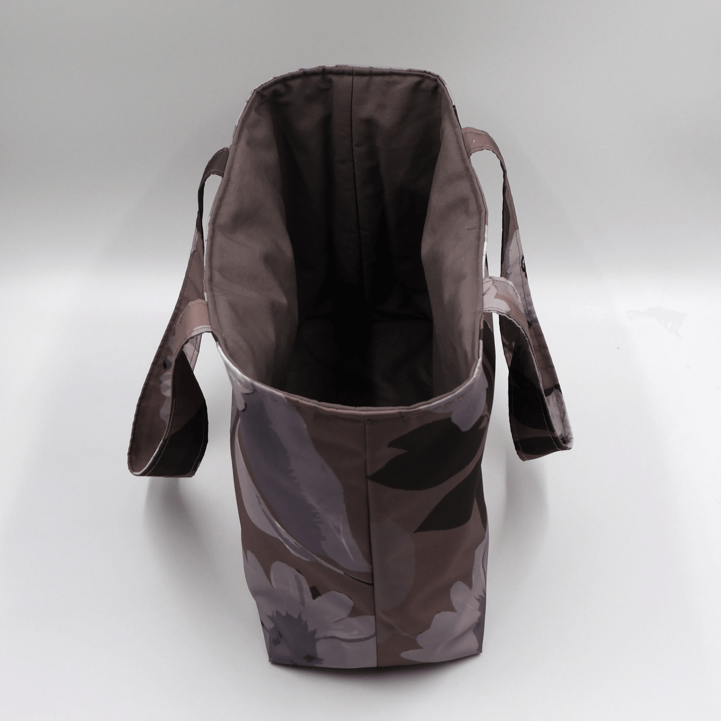 Teacher/book bag with light grey and mauve floral design on a dark mauve background. Carry books and crafts. Without plastic inner.