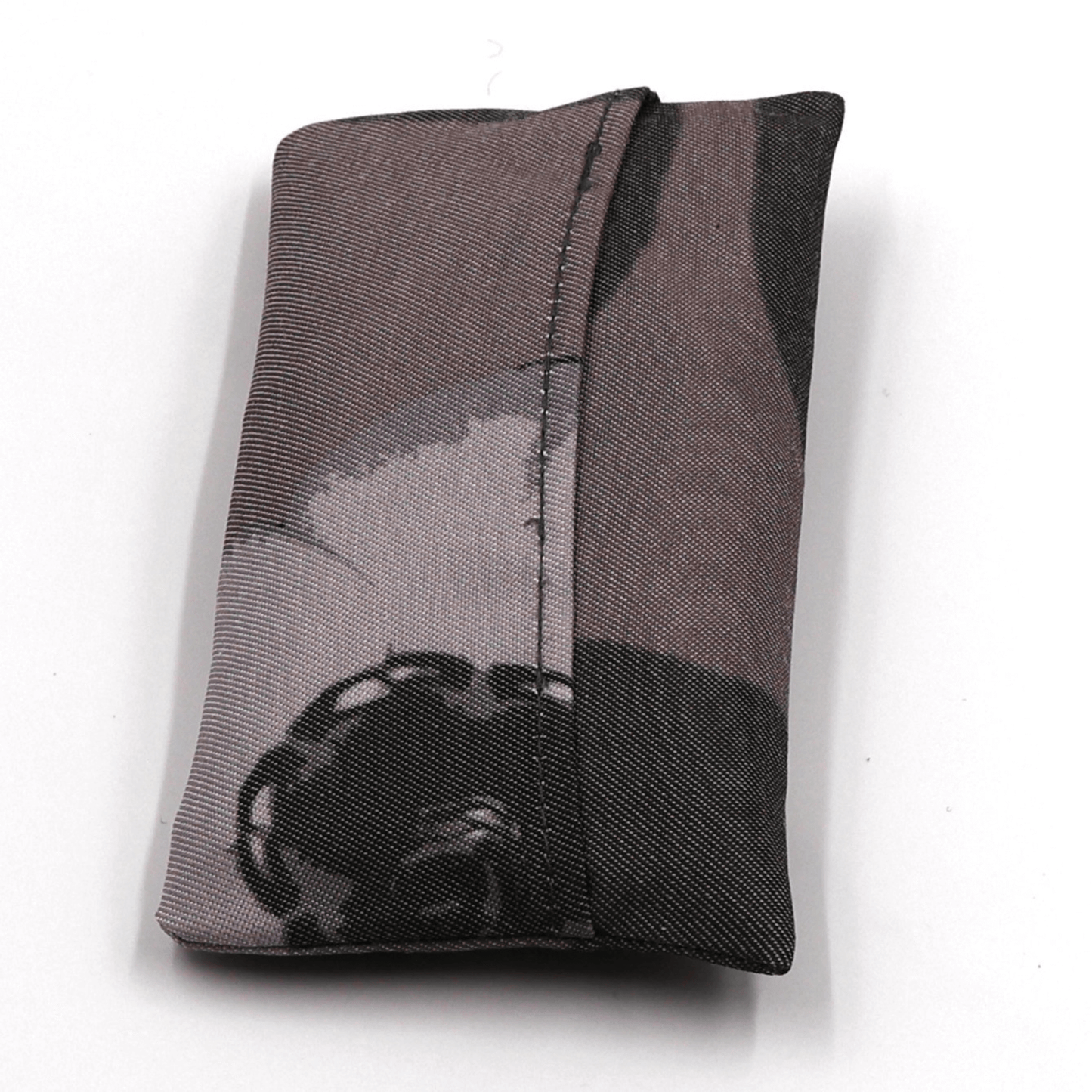 Fold up shopping bag with daisy floral design in dark and light greys and mauve. Fold view.