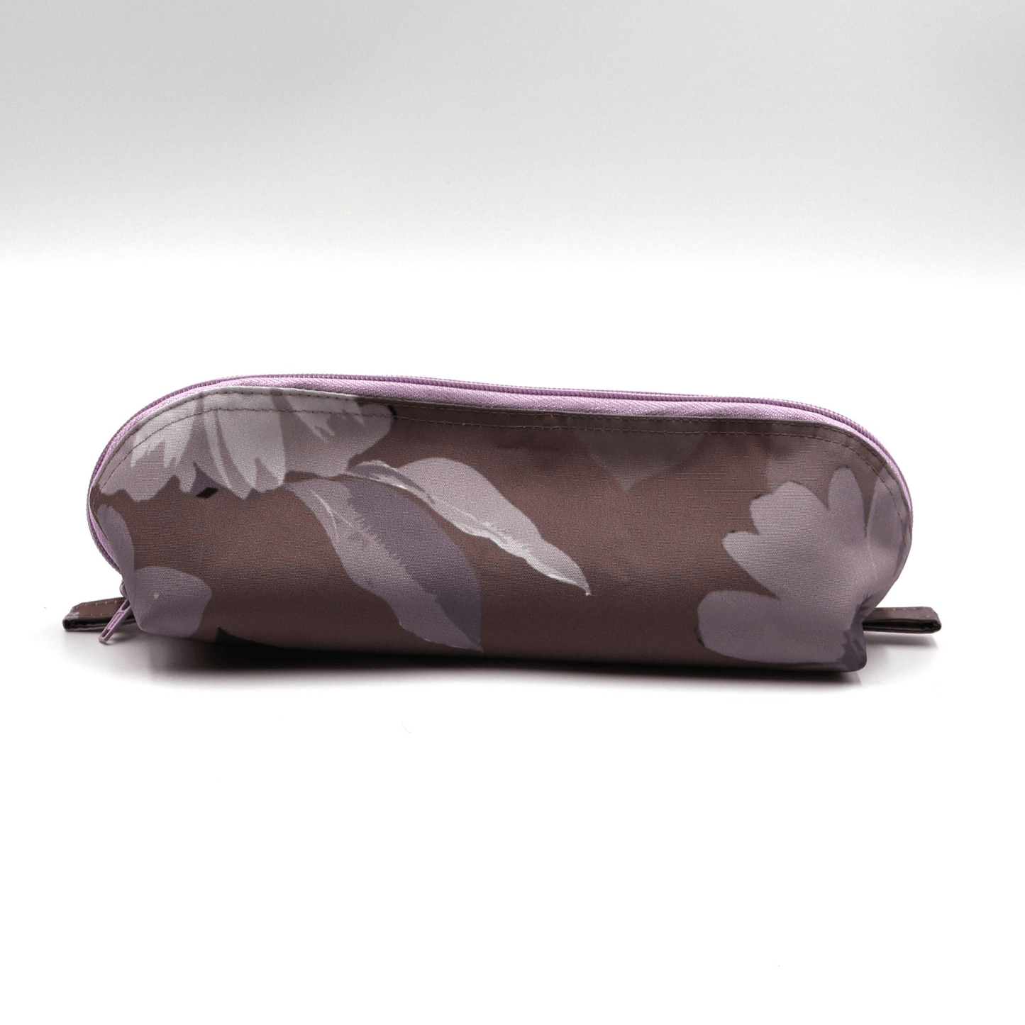 Pencil bag in soft mauve and dark grey daisy floral design on dark mauve background.