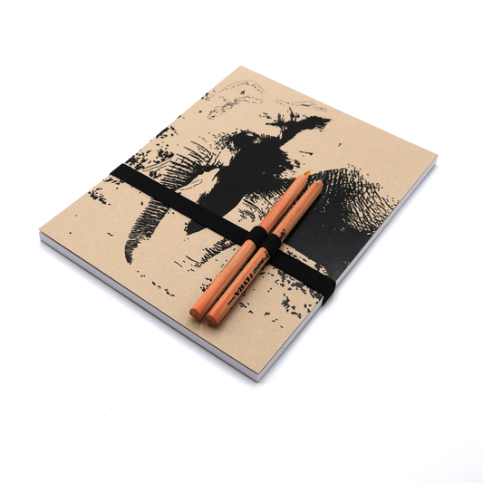 A4 Sketchpad with pencils and pencil holder with adult elephant design on a beige/sand background.