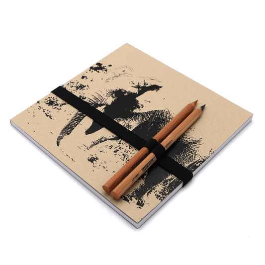 Square art pad with pencils and pencil holder with adult elephant design on a beige/sand background.