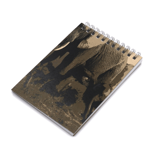 A6 Notebook with elephant family design in brown on a beige/sand background. Top binding.