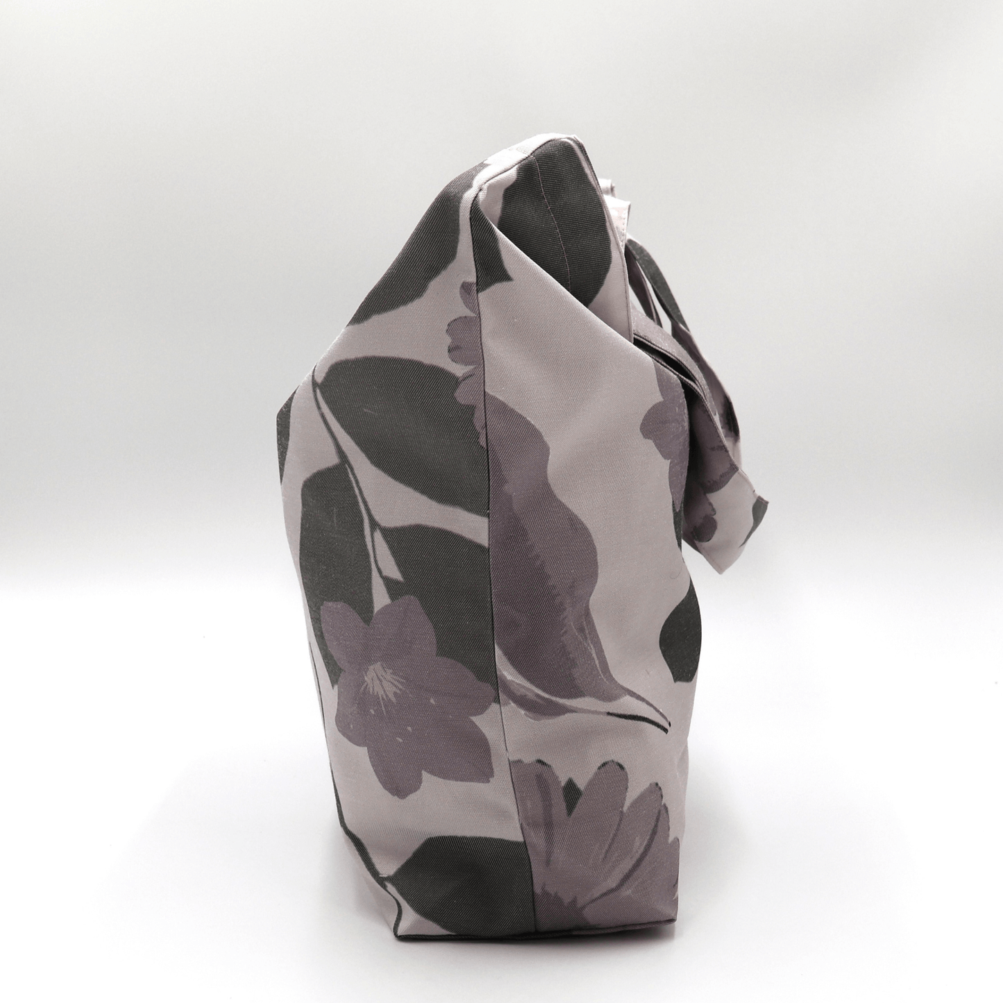 A beautiful, high-quality tote bag with a mauve and grey Daisy floral design. Side angle.