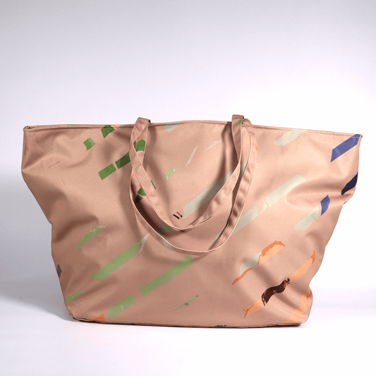 A dusky peach carryall bag with a multi-colour stripe design.