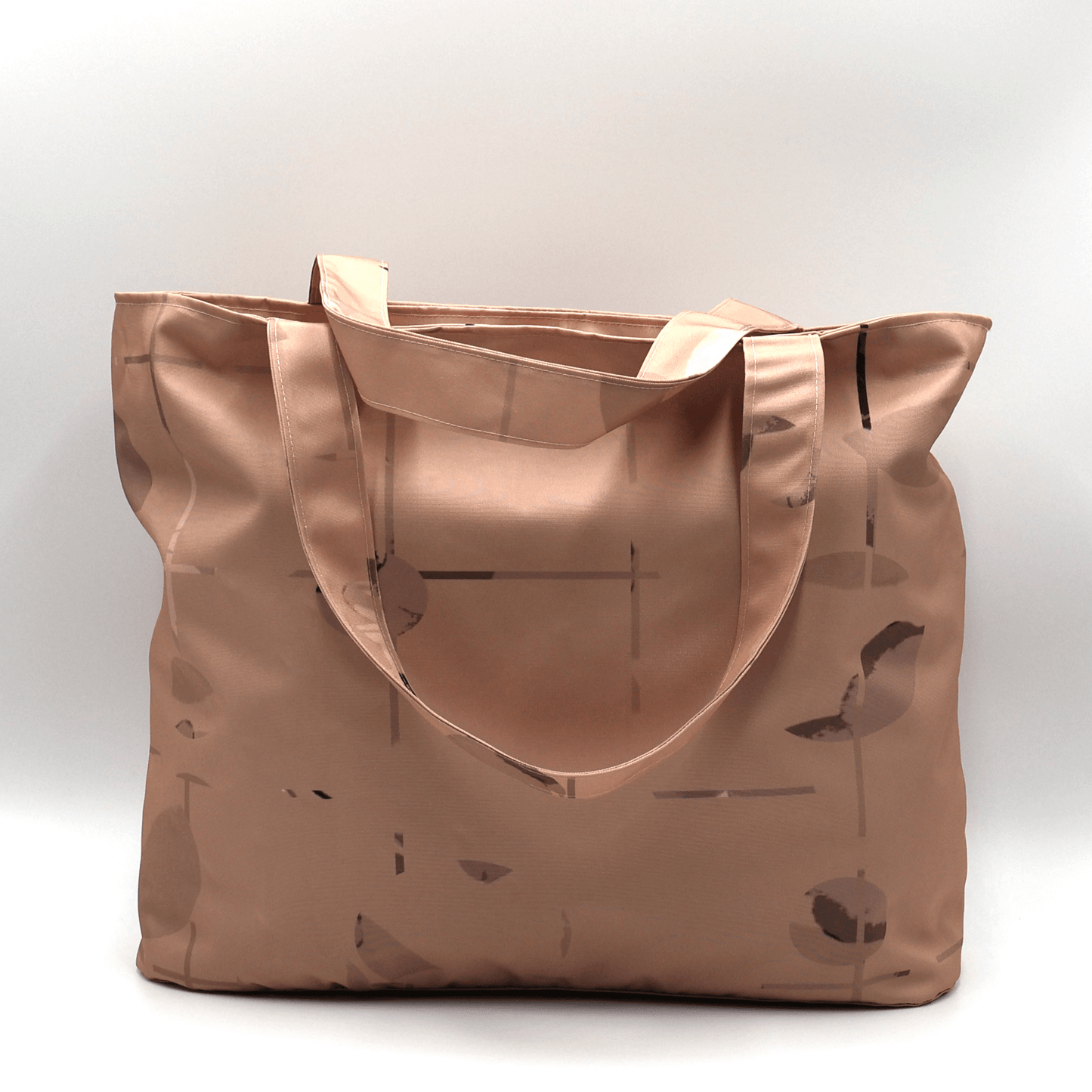 Shoulder bag with geometric/floral design in rusty orange and brown. Perfect for carrying books and documents.