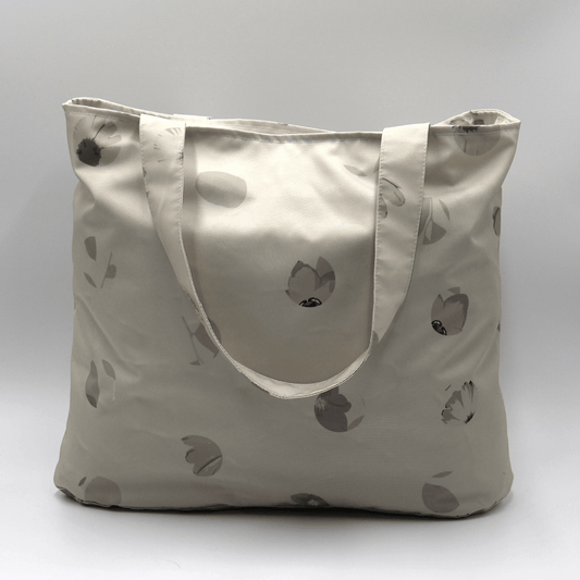 Shoulder bag with daisy floral design in beige, ivory and taupe. Perfect for carrying books and documents.