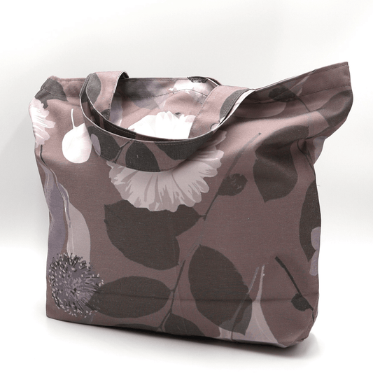 A dusky mauve tote bag with Daisy floral design. Durable and easy to clean. Side angle view.