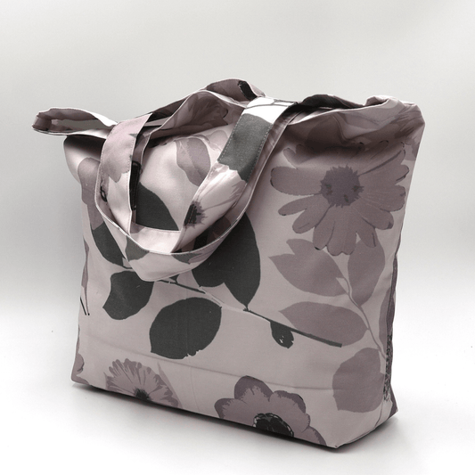 A beautiful, high-quality tote bag with a mauve and grey Daisy floral design. Side view.