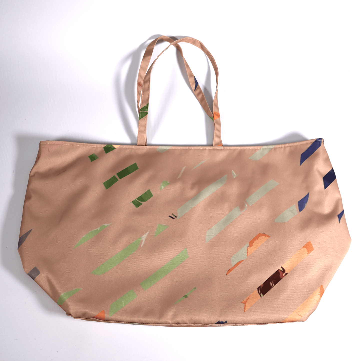 A dusky peach carryall bag with a multi-colour stripe design. Flat view.