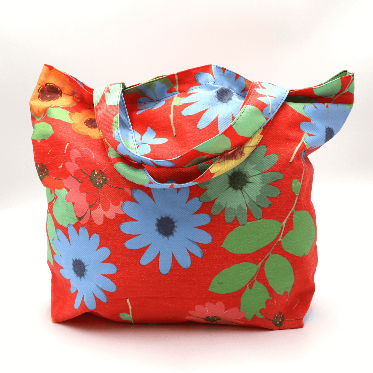 A bright, beautiful tote bag with Daisy design on a red background. Perfect finishes. Carry shopping and books.