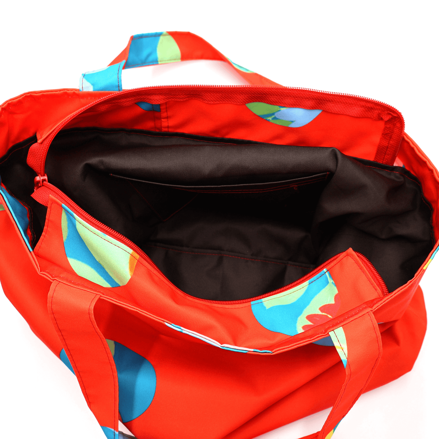 Shoulder bag with bright daisy floral design on a red background. Perfect for carrying books and documents. Inside view.