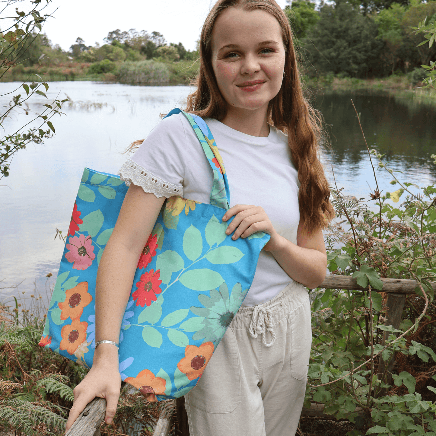 Model with bright Blue Daisy tote bag.