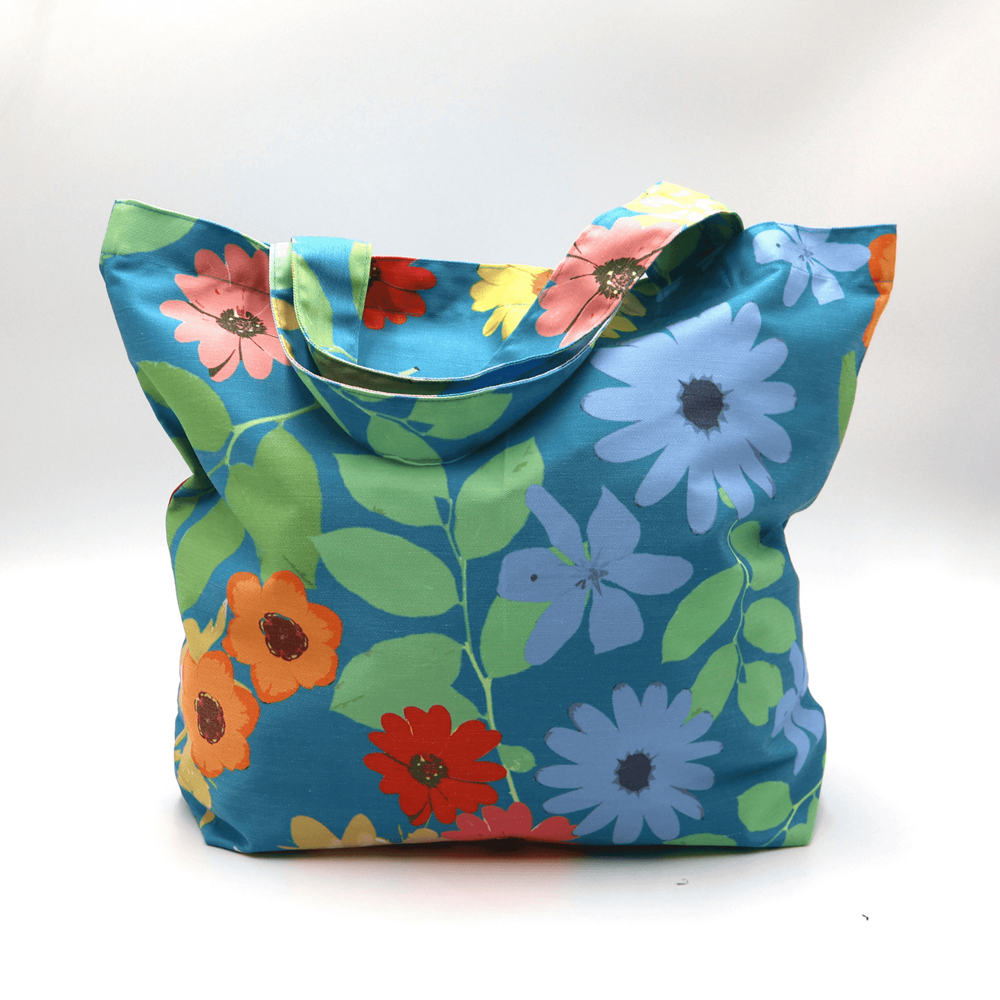 A bright, beautiful tote bag with Daisy design on a blue background. Perfect finishes. Carry shopping, essentials and books.