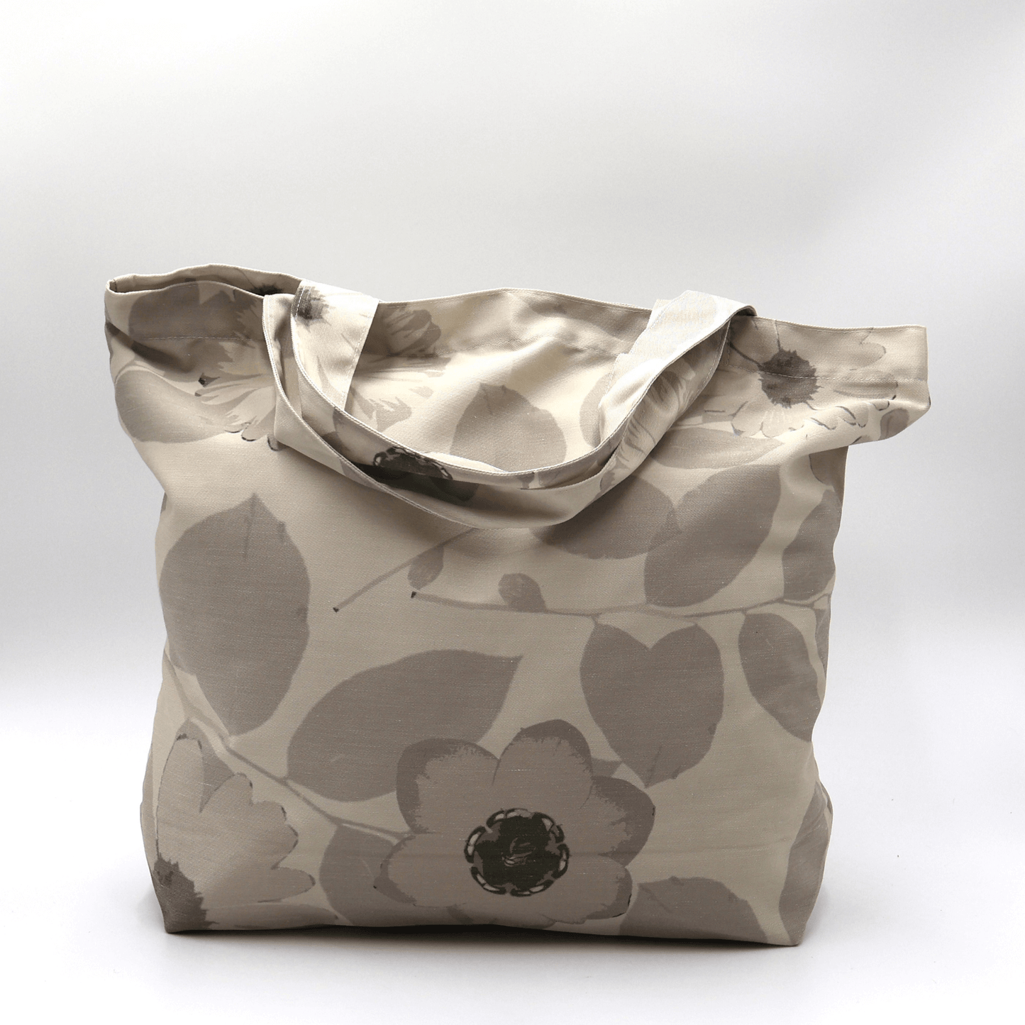 A durable, designer tote bag in light and dark beige daisy floral tones. Carry essentials, books and shopping.