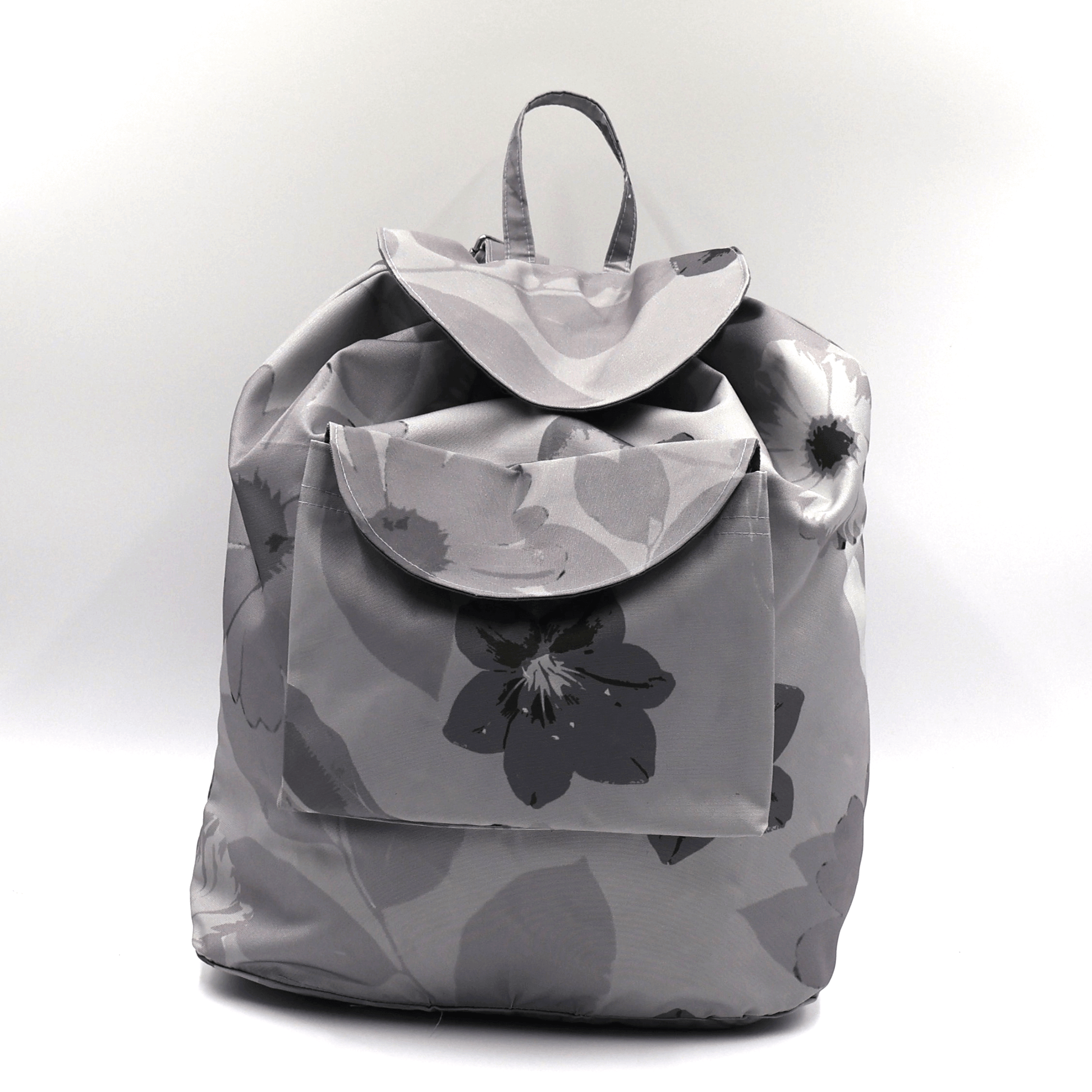 Backpack with drawstring and daisy floral design in dark and light greys.