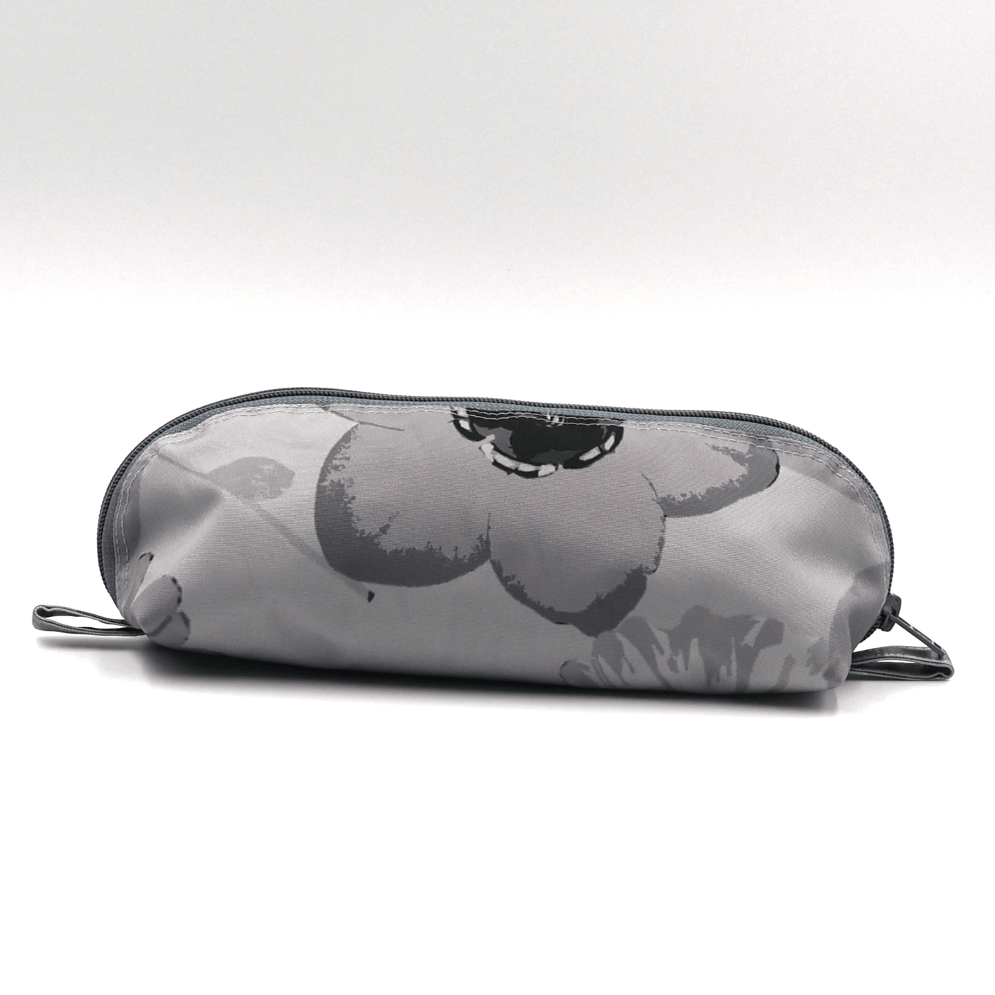 Pencil bag in soft and dark grey daisy floral design on light grey background.