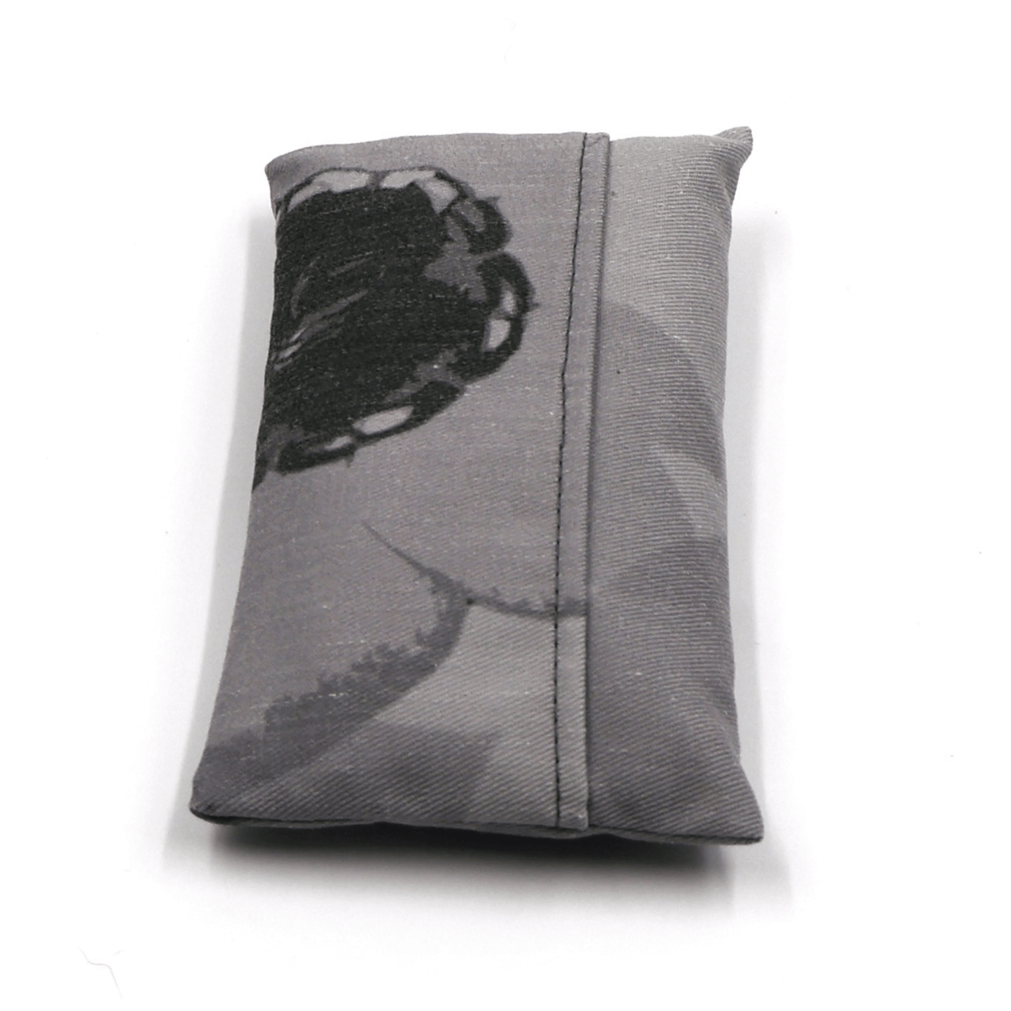 Fold up shopping bag with daisy floral design in dark and light greys. Fold view.