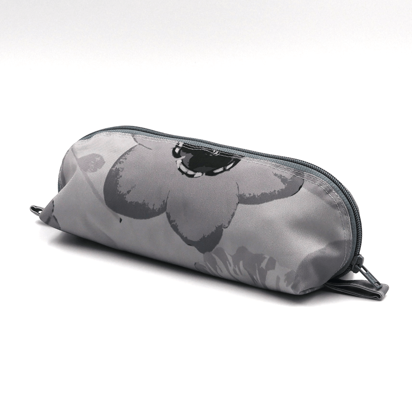 Pencil bag in soft and dark grey daisy floral design on light grey background. Side view.