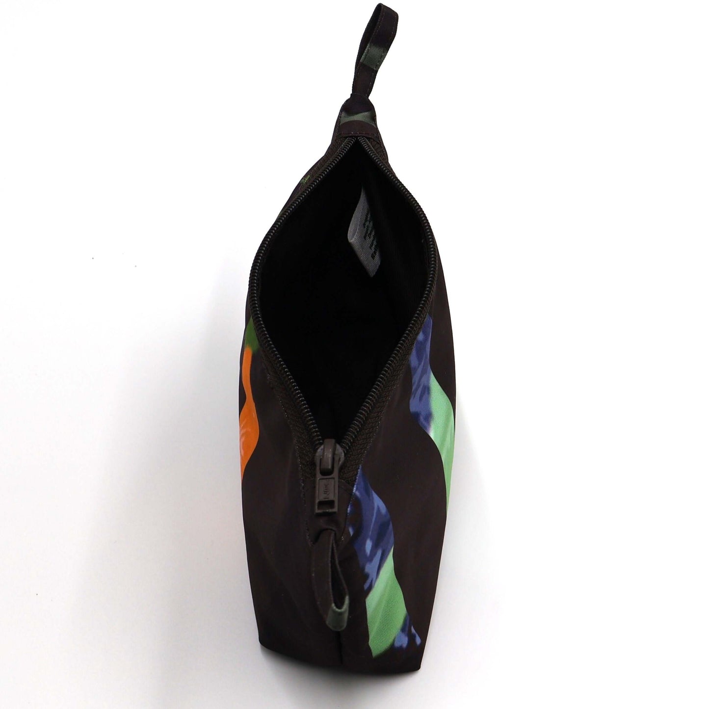 Dark brown/black makeup bag with white colorful floral, stripe design. Open top.