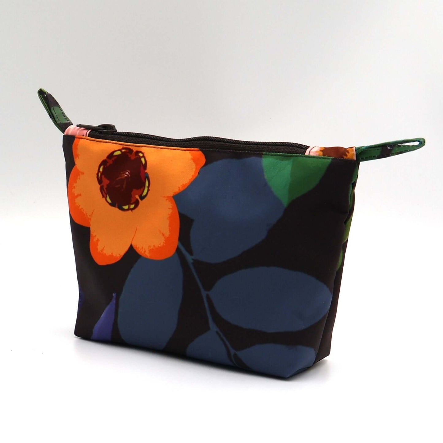 Dark brown/black makeup bag with colorful floral design. Side view.