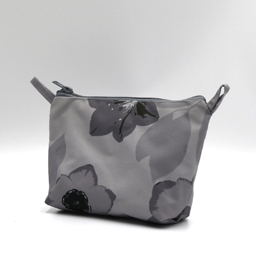 Ellie Bosch dark and light grey floral makeup bag, zipped closure, perfect for organizing beauty products. Side view.