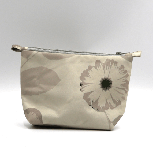 Ellie Bosch beige and ivory floral makeup bag, zipped closure, perfect for organizing beauty products.
