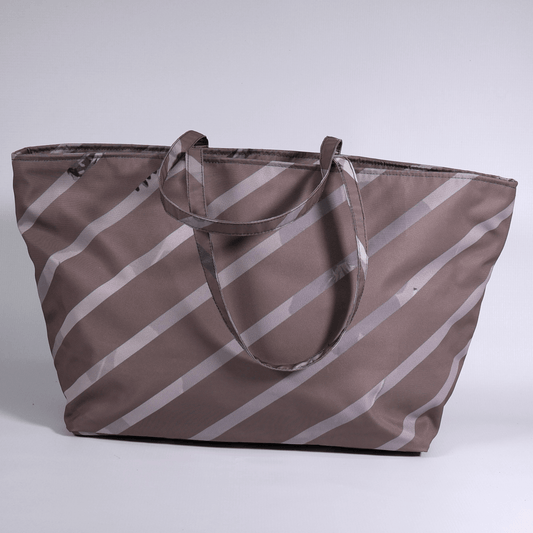 A dark mauve carryall bag with light grey diagonal stripe design.